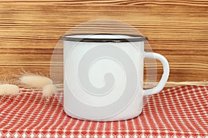 Campfire enamel white metal mug with black line on the edge. Old tin cup design template photo