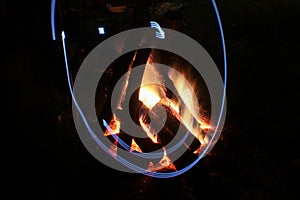 Campfire in fire pit at campsite.