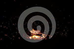 Campfire flame sparks isolated on black background. Fire flames heat energy heap in the night. Fire sparkles isolated on