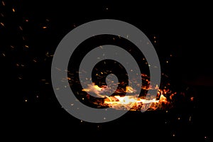 Campfire flame sparks isolated on black background. Fire flames heat energy heap in the night. Fire sparkles isolated on