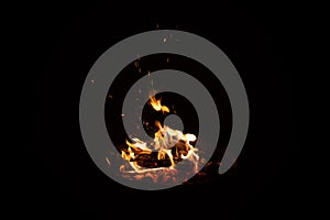 Campfire flame sparks isolated on black background. Fire flames heat energy heap in the night. Fire sparkles isolated on