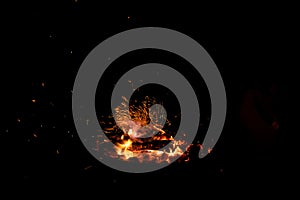 Campfire flame sparks isolated on black background. Fire flames heat energy heap in the night. Fire sparkles isolated on