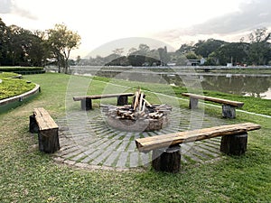 campfire riverside with bench and firewood no people. landscape view.