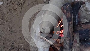 Campfire on the sandy bank of the river. Top view