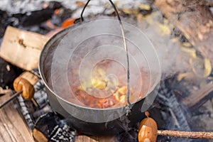Campfire soup in iron kettle