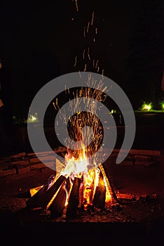 Campfire Sparks Soaring into the Night Sky