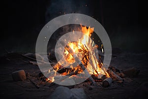 Campfire at touristic camp in the night. Flame and fire sparks on dark background. Generative AI