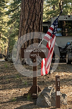 Campground Host Sign With American Flag Mounted On It