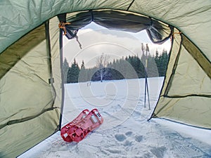 Campin on snow. Tent set on frozen snowy lake. photo