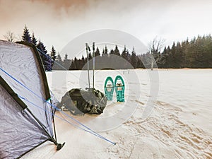 Campin on snow. Tent set on frozen snowy lake. photo