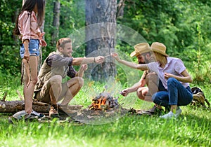 Camping activity. Company friends prepare roasted marshmallows snack nature background. Company youth camping forest