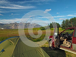 Camping adventure in Iceland - tent and old off-road car with op