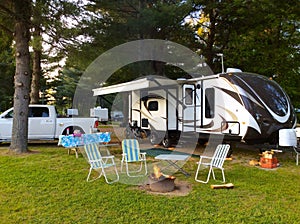 Camping on the campground with travel trailer photo