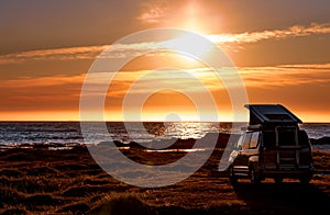 Camping car minivan on the beach at sunset Lofoten beach