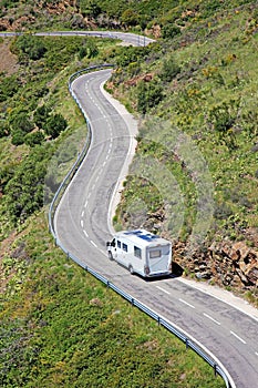 Camping caravan car camper on road Europe european Spain France holiday aerial view trip curvy trailer camp driving travel drive