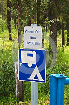 A camping check out time 12:00 pm message sign