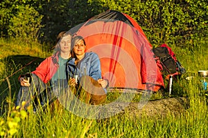 Camping couple sitting and enjoying sunset