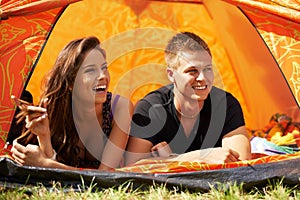 Camping couple. a young couple lying in a tent together.