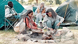 Camping, friends and fire wood in nature for heat by tent on adventure, holiday or vacation in forest. Diversity, travel