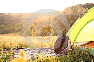 Camping gear and tourist tent in wilderness