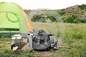 Camping gear and tourist tent in wilderness. Tourist equipment