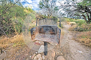 Camping grill post near the trail and picnic table at Tucson, Arizona