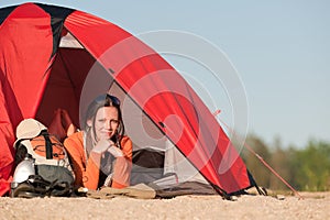 Camping happy woman in tent on beach