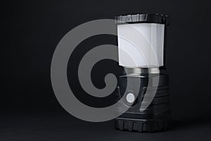 Camping lantern on black background, space for text. Military training equipment