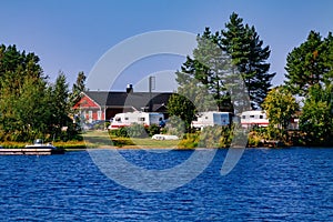 Camping life with caravans in nature park by the lake