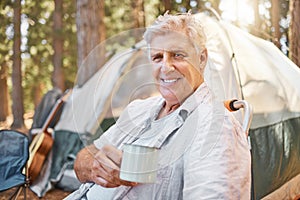 Camping, morning and portrait of senior man with coffee on holiday or vacation adventure in a forest or woods. Smile