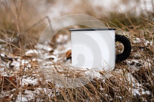 Camping mug in winter forest background.