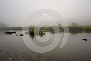 Camping in the nature waking up into a misty sunrise