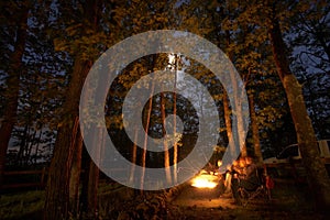 Camping at night with a fire photo