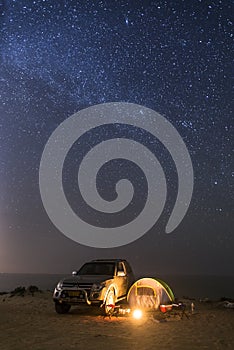 Camping at night under a sky full of stars