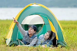 Camping outdoor. Group  friends camping leisure and destination travel. Family sitting around camp fire and playing guitar and roa