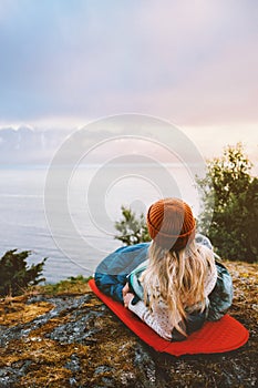 Camping outdoor woman laying on sleeping pad bivouac gear travel vacations girl hiking solo in mountains photo