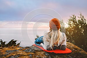 Camping outdoor woman relaxing on sleeping pad bivouac gear travel lifestyle vacations girl hiking alone in mountains