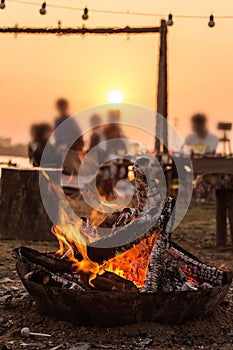 Camping, picnicking and bonfire in the sunset