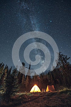 Camping in pine forest with milky way and shooting star at Assiniboine provincial park