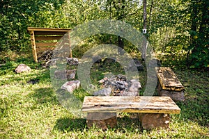 Camping place with fireplace and benches in the forest