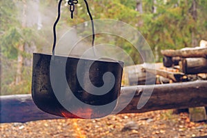 Camping pot on fire. Outdoor steaming food. Wildlife lifestyle cooking delicious meal  Copyspace stock photography