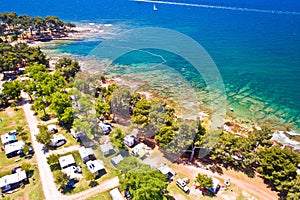 Camping by the sea and crystal clear stone beach aerial view in Savudrija