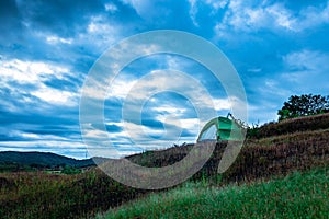 Camping solo at mountain top with amazing view and dramatic sky at evening