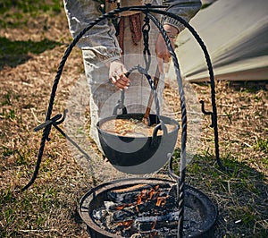 Camping. Soup in a pot over a fire