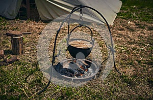 Camping. Soup in a pot over a fire