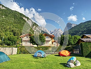 Camping within summer holiday. Trekking tents in touristic camp in Italien Alps