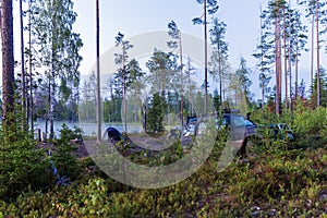 Camping tent with a car near lake outdoors