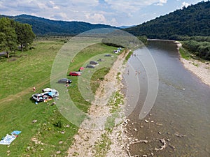 camping tent with car near mountains river