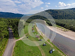 camping tent with car near mountains river