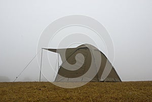 Camping tent in the fog